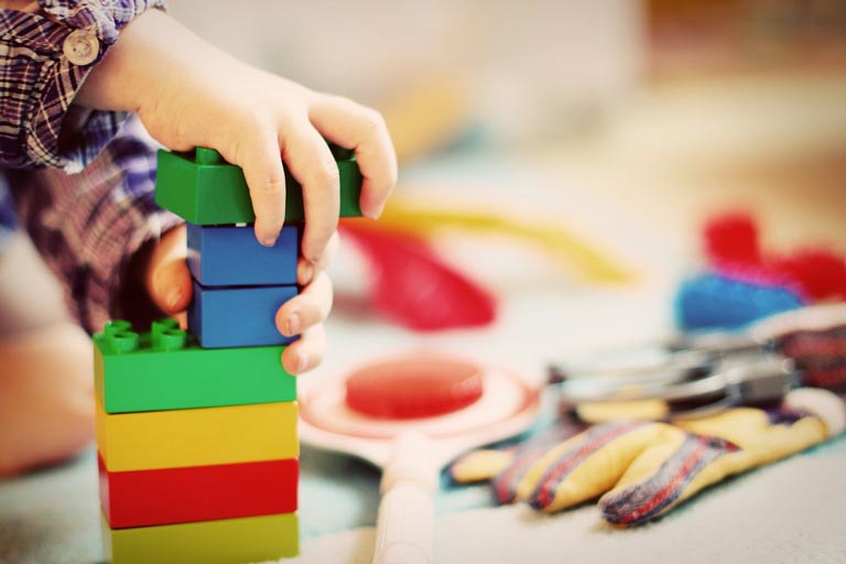 Kid's hand with Lego